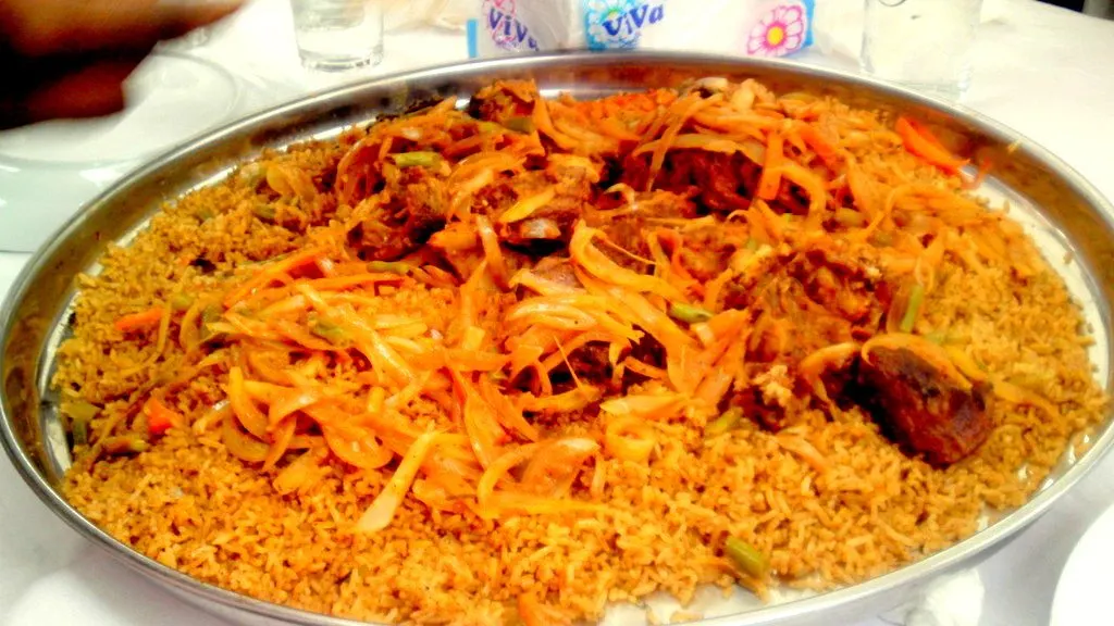Jollof rice is a one-pot rice dish with tomatoes, vegetables & spices