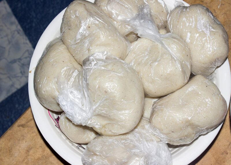 Banku on a plate wrapped in plastic