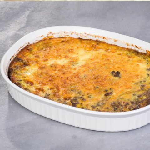 Food with crispy cheese on top in a white dish