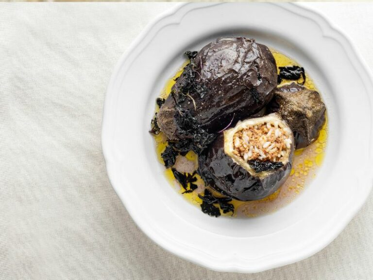 Stuffed eggplants in oil on a white plate