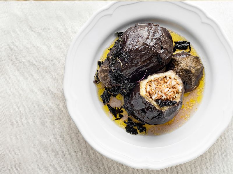 Stuffed eggplants in oil on a white plate