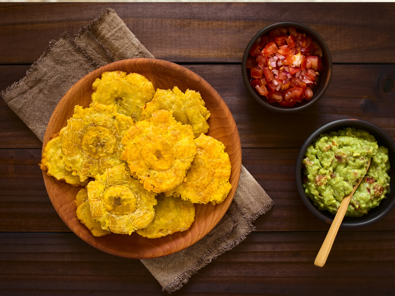 Fried plantain on a brown bowl with side dips