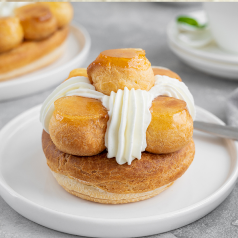 French pastry with fresh whipped cream on a white plate