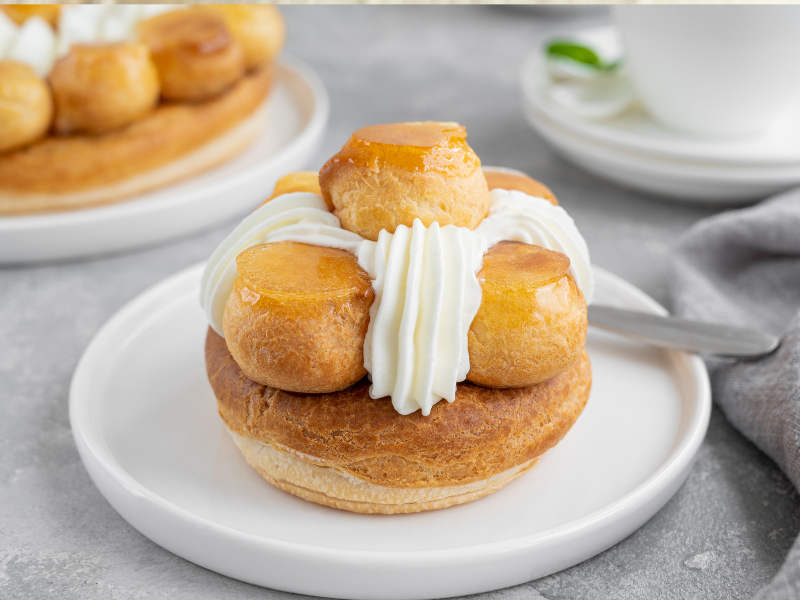 French pastry with fresh whipped cream on a white plate