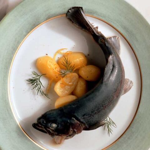 Blue trout served with potatoes.
