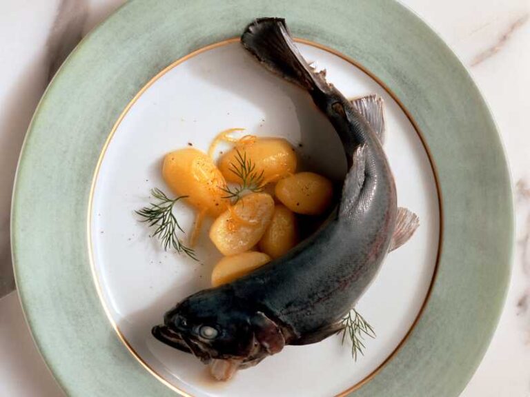 Blue trout served with potatoes.