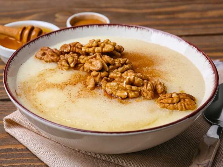Semolina pudding garnished with walnuts and cinnamon.